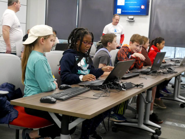 Associates from World Wide Technology work with St. Louis-area students at the Hour of Code event, part of the company’s STEM initiatives.