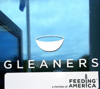 Exterior Signage for Gleaners Food Bank showing that they are supported by Feeding America.