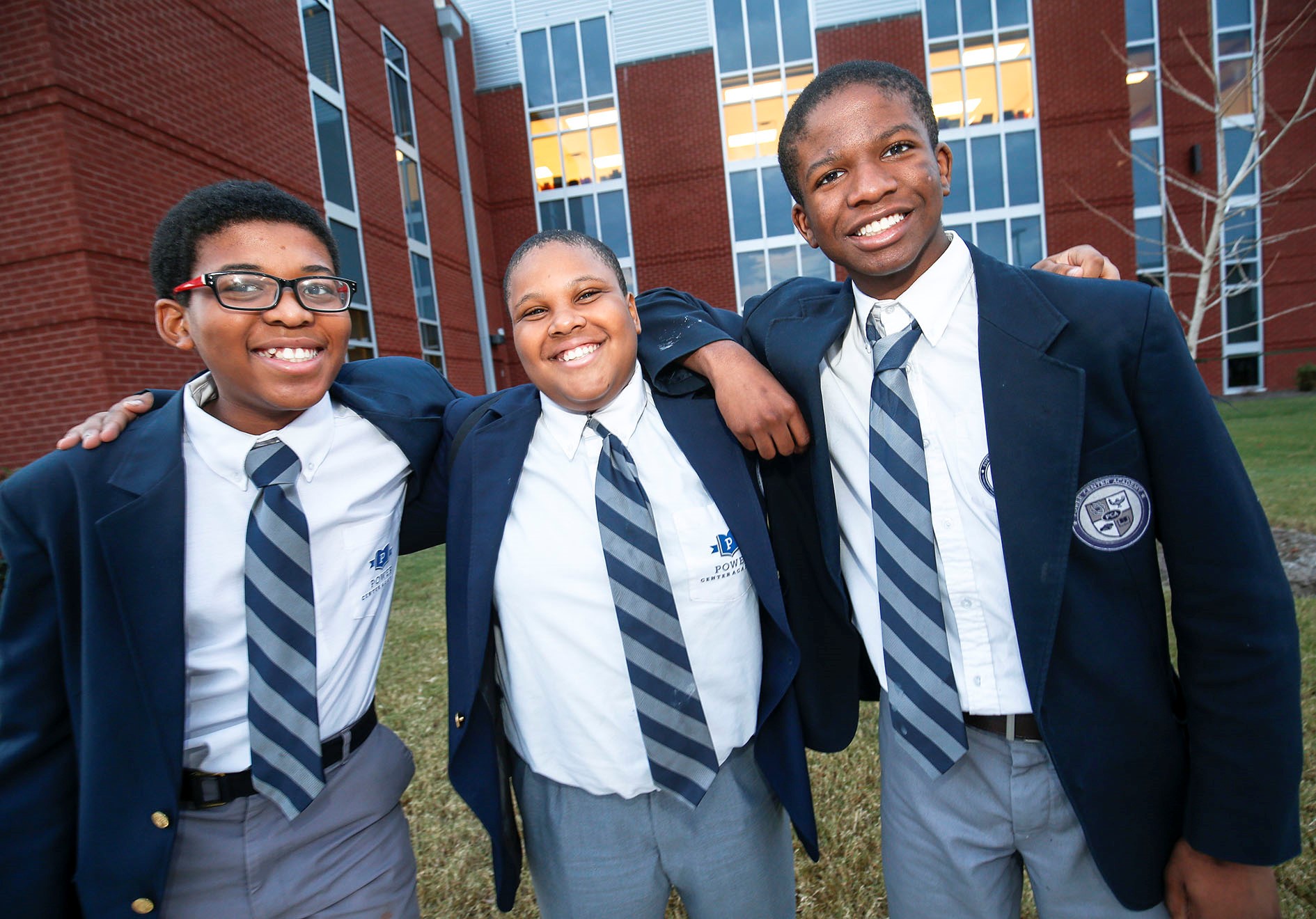 three students smiling at camera